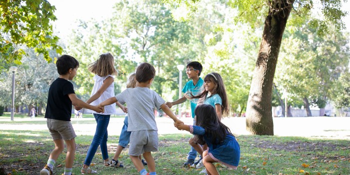 happy-children-playing-together-outdoors-dancing-around-grass-enjoying-outdoor-activities-having-fun